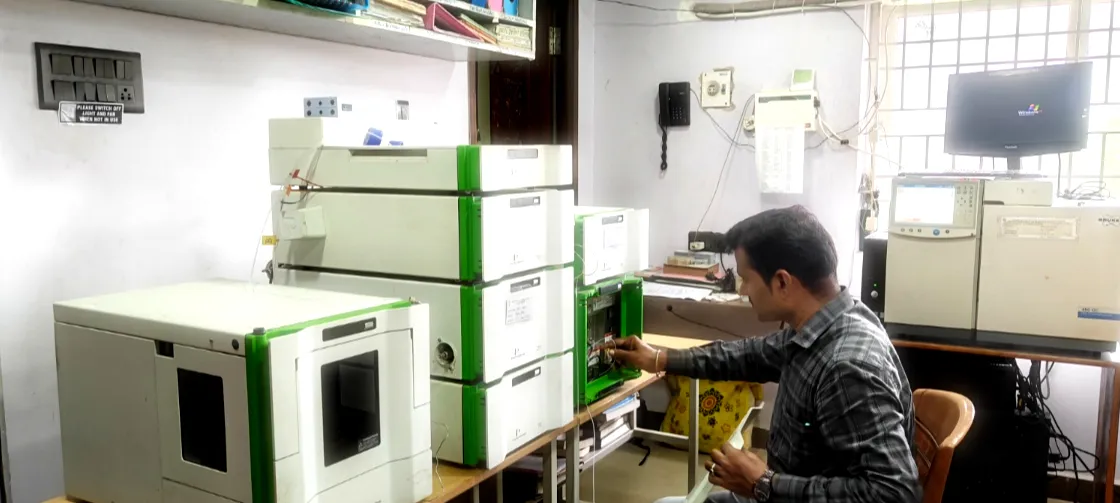 Engineer servicing an HPLC instrument